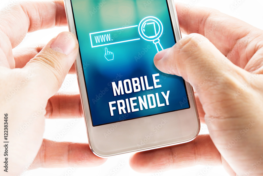 Wall mural close up two hand holding mobile phone with mobile friendly and