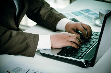 working on laptop, close up of hands of business man