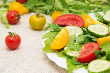 Fresh salad with tomatoes, rucola and cucumbers
