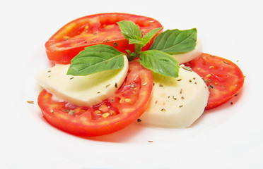 Caprese salad with mozarella cheese, tomatoes and basil