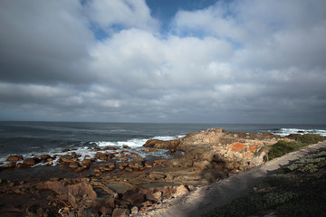 Fototapeta na wymiar rocky beach with cloudy sky in South Africa