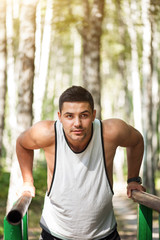 Pleasant nice sportsman working out outdoors