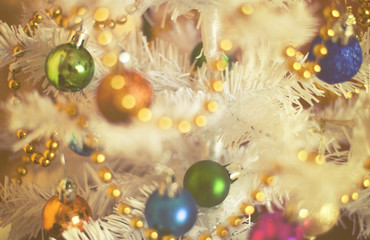 Fototapeta na wymiar Christmas decorations on artificial fir, xmass background vintage effect