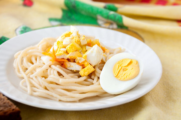 A dish of spaghetti and eggs for breakfast  