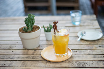Ice litchi tea on wood table with dishes