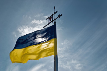 Ukrainian flag waving next to clear sky