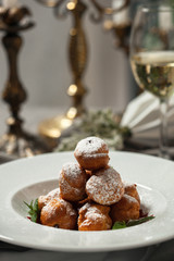 Profiteroles with whipped cream and powdered sugar