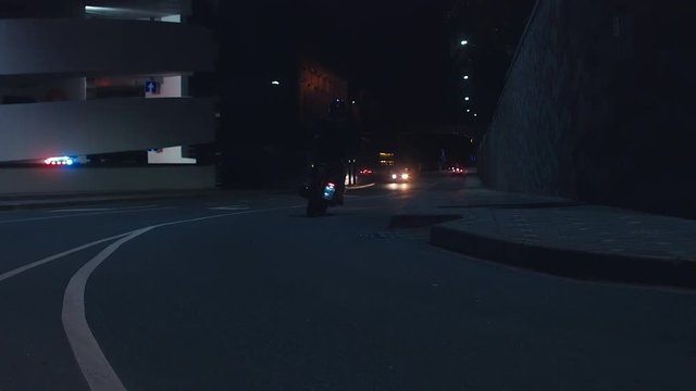 WIDE a group of motorcyclist ride in the streets at night. 60 FPS