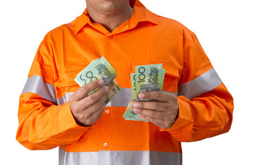 Supervisor or work man with high visibility shirt  holding and countind australian dollar as wages or reward