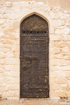 Old cast iron wrought iron door decorated with Arabic script