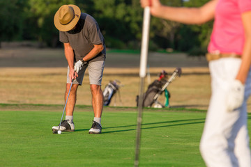 Obraz premium Happy Senior Couple Playing Golf