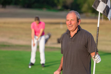 Happy Senior Couple Playing Golf