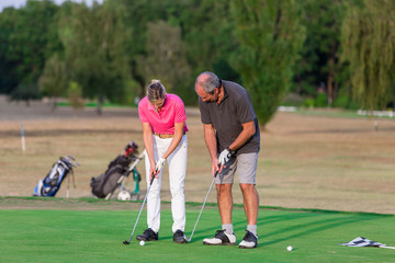 Senior Couple Enjoying Game Of Golf