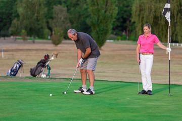 Senior Couple Enjoying Game Of Golf