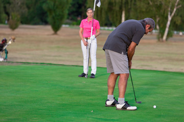 Senior Couple Enjoying Game Of Golf