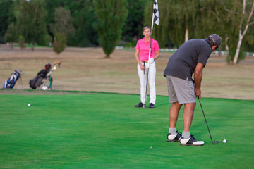 Senior Couple Enjoying Game Of Golf