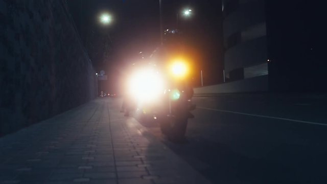 MED a group of motorcyclist ride in the streets at night. 60 FPS