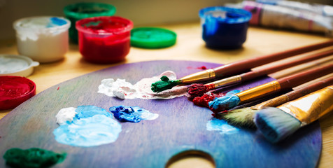 artist's workshop. Easel with brushes and tubes of paint