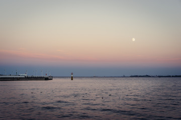 Fototapeta na wymiar Quiet evening with full moon by the bay of Gdansk, Pomeranian, Poland