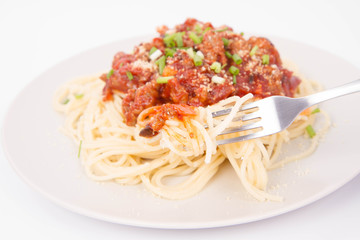 Spaghetti bolognese being eaten with a fork