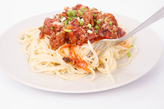 Spaghetti bolognese being eaten with a fork