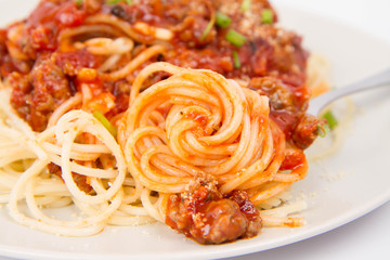 Spaghetti bolognese being eaten with a fork