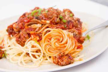 Spaghetti bolognese being eaten with a fork