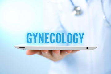 Gynecology concept. Professional doctor with tablet on blue background