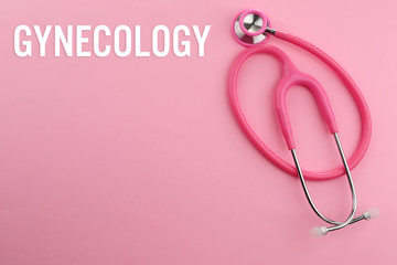 Fototapeta premium Gynecology concept. Pink stethoscope on pink background