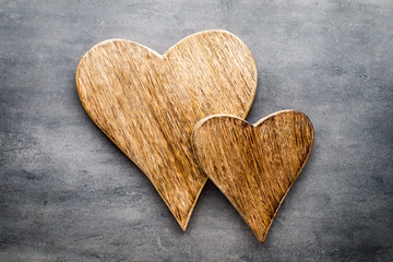 Two vintage hearts on gray metal background.
