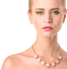 Portrait of young woman with beautiful necklace on white background