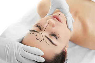 Plastic surgery concept. Specialist checking female face