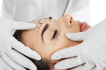 Fototapeta na wymiar Plastic surgery concept. Specialist checking female face