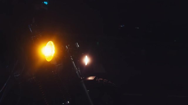 Bikers turn on headlight of their motorbikes in the street at night. 4K 60 FPS slow motion shot