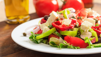 Greek salad on wooden background