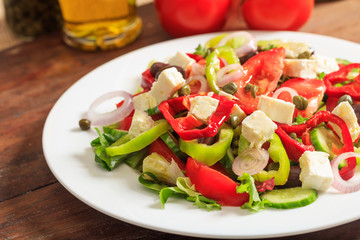 Greek salad on wooden background