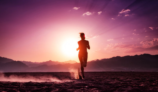 Lady Running In The Desert At Sunset