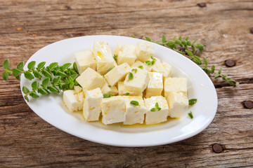 Feta cheece pieces on wooden background