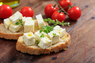 Feta cheece pieces on wooden background