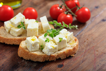 Feta cheece pieces on wooden background