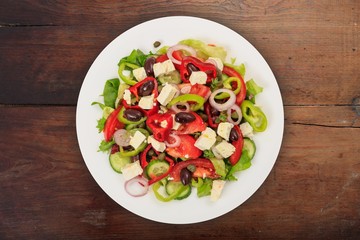 Greek salad on wooden background