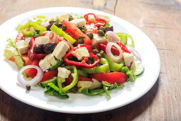 Greek salad on wooden background