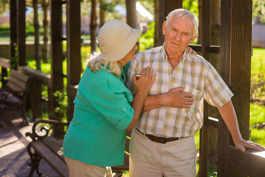 Senior Man Has Heart Ache. Elderly Couple Outside. I Feel Pains Again. Husband Has Chronic Illness.