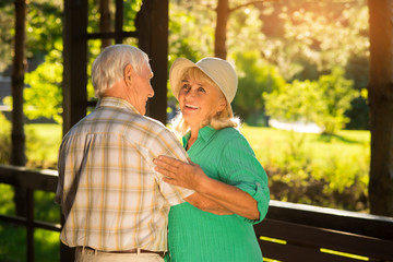Smile of elderly woman. Dance of senior couple. Waltz at midday. Devotion and unity.