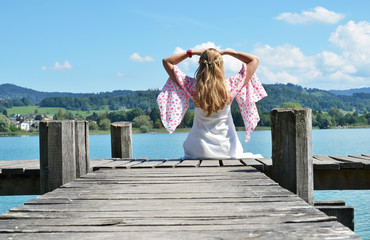 Girl on the wooden jetty at the lake. Switzerland - 122401047