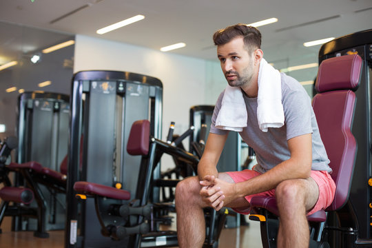 Sportsman with Towel on Neck Having Rest in Gym
