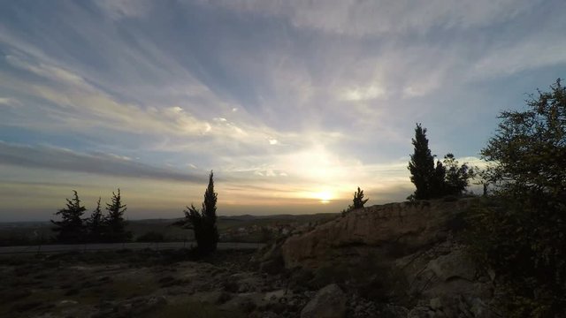 Time-lapse sunset in the mountains with a settlement in the background