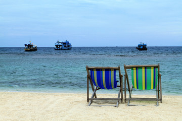 Two deckchairs on the beach