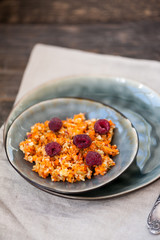 Fruit salad with apples, carrots and raspberries