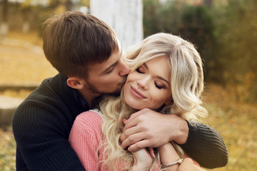 Fototapeta premium fashion outdoor photo of beautiful tender couple, wearing cozy clothes, walking by autumn park 